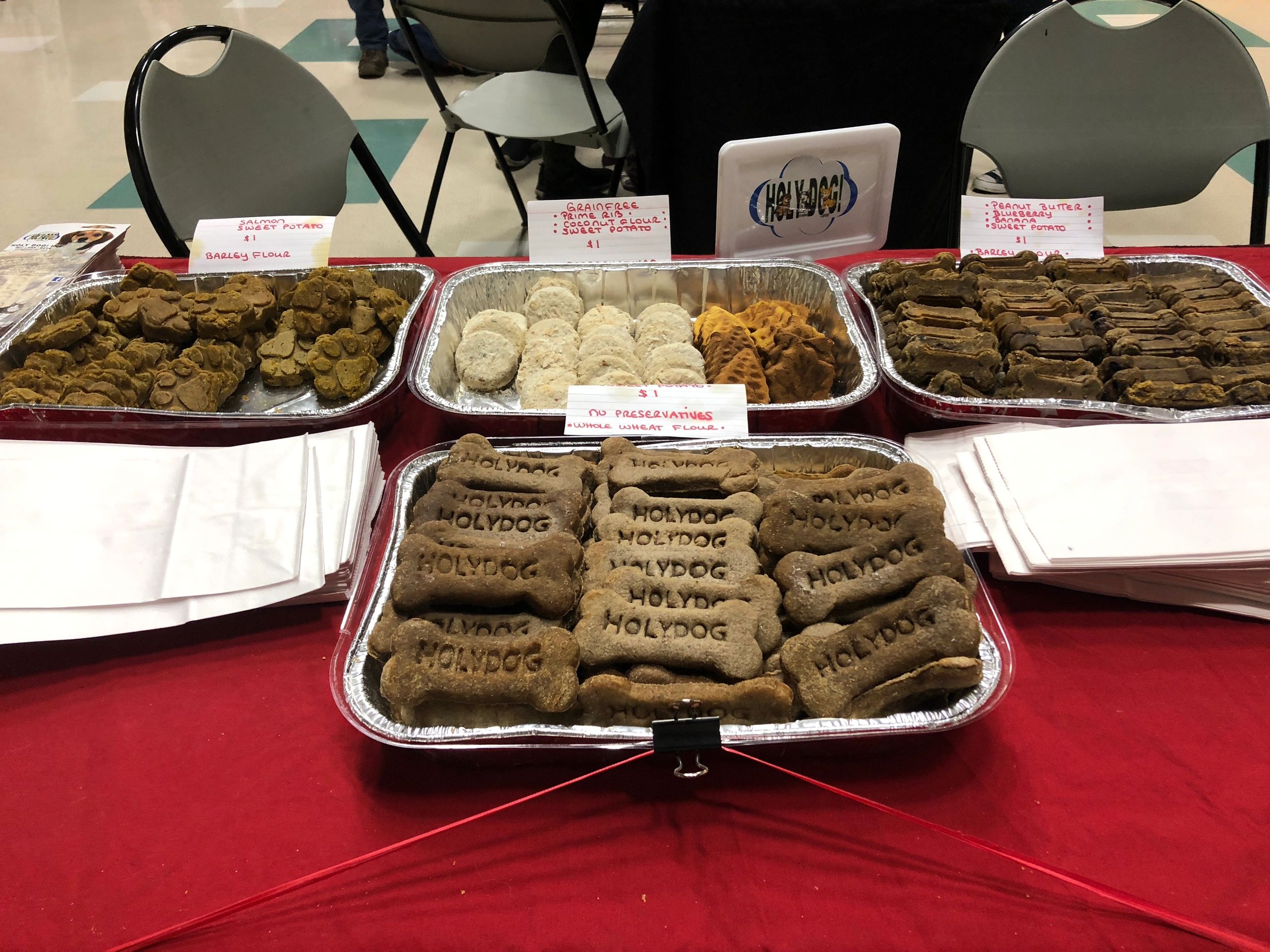 Variety of pet snacks on red table
